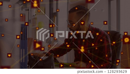 Man in office using tablet surrounded by digital interface icons and connections Man in office using tablet surrounded by digital interface icons and connections 128293629