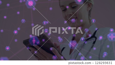 Using digital medical interface on tablet, healthcare professional smiling confidently 128293631