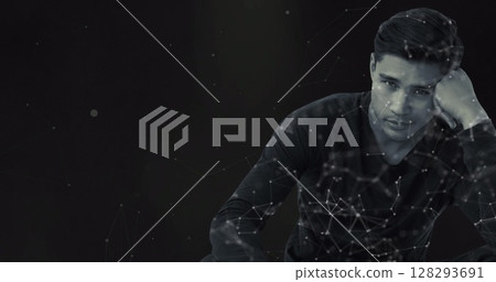 Pensive man in dark room surrounded by digital network connections Pensive man in dark room surrounded by digital network connections 128293691