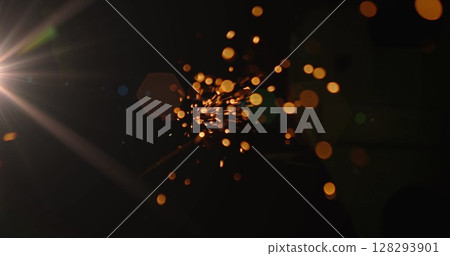 Bright sparks flying in dark space creating dynamic abstract visual effect Bright sparks flying in dark space creating dynamic abstract visual effect 128293901