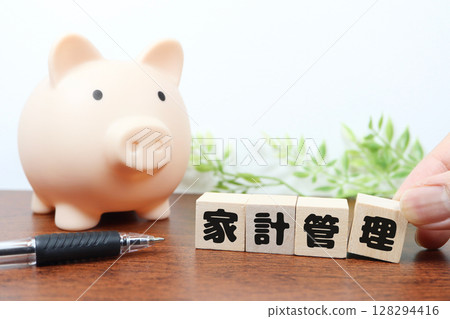 Photo of a piggy bank and building blocks for household management - saving image Photo of a piggy bank and building blocks for household management - saving image 128294416