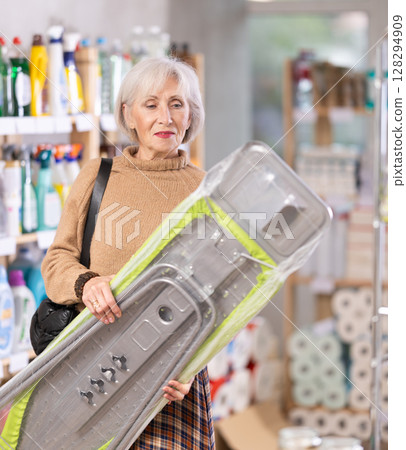 Woman choosing an ironing board 128294909