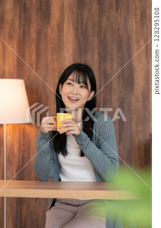 A young woman relaxing in the room A young woman relaxing in the room 128295108