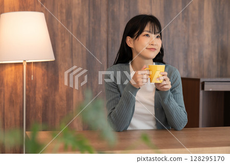 A young woman relaxing in the room 128295170