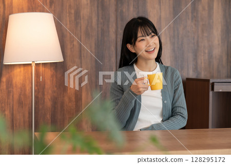 A young woman relaxing in the room A young woman relaxing in the room 128295172