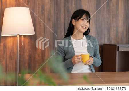 A young woman relaxing in the room A young woman relaxing in the room 128295173