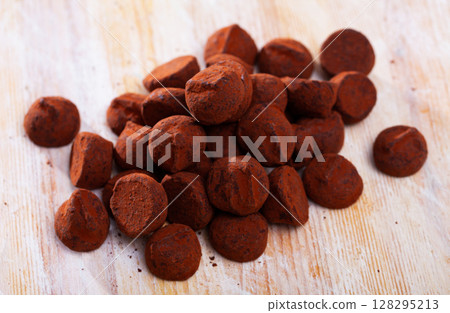 Chocolate truffles on wooden background Chocolate truffles on wooden background 128295213