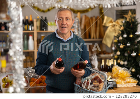 Elderly man choosing whiskey in grocery store Elderly man choosing whiskey in grocery store 128295270