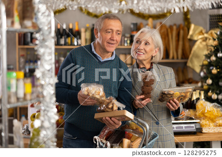 Elderly spouses choose consider nougat, panettone, marzipan, cookies, chocolate 128295275