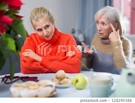 Home quarrel between mom and daughter during christmas closeup 128295388