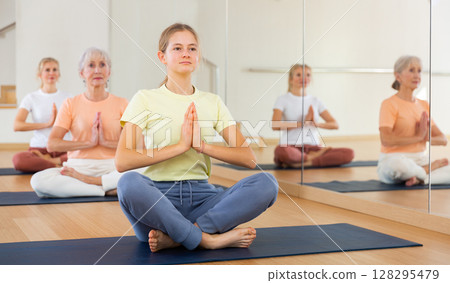 Girl making yoga meditation in lotus pose 128295479