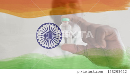 Image of male doctor holding vaccine bottle over indian flag 128295612