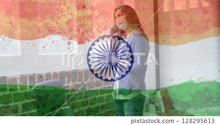 Composition of woman wearing face mask over indian flag 128295613