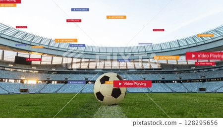 Image of social media icons on banners over football on pitch 128295656