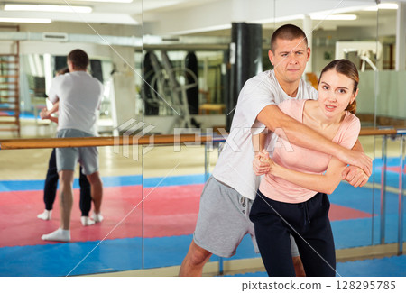 Active woman training captures on self-defense course 128295785