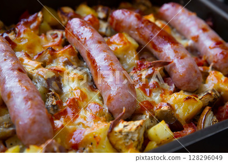 Baked vegetables with sausages 128296049