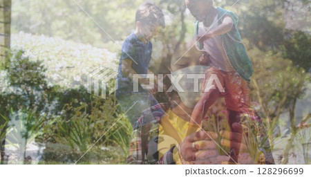 In school, child using smartphone while Asian woman observes screen 128296699