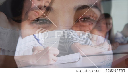 Digital composition of asian woman wearing face mask against college student studying at college Digital composition of asian woman wearing face mask against college student studying at college 128296765