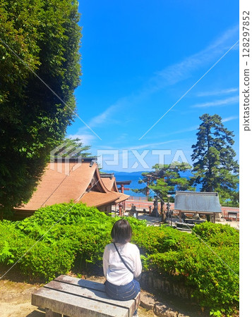 A person taking a break while looking at the blue sky and greenery A person taking a break while looking at the blue sky and greenery 128297852