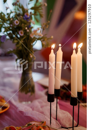 Romantic Candlelit Dinner Table Setting with Flowers and Soft Lighting, Lavender Tones, Intimate Atmosphere, Cozy Interior Decor Romantic Candlelit Dinner Table Setting with Flowers and Soft Lighting, Lavender Tones, Intimate Atmosphere, Cozy Interior Decor 128297910