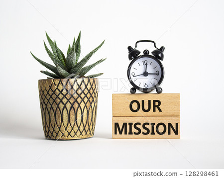 Our Mission symbol. Wooden blocks with words Our Mission. Beautiful white background with alarm clock and succulent plant. Business and Our Mission concept. Copy space. 128298461