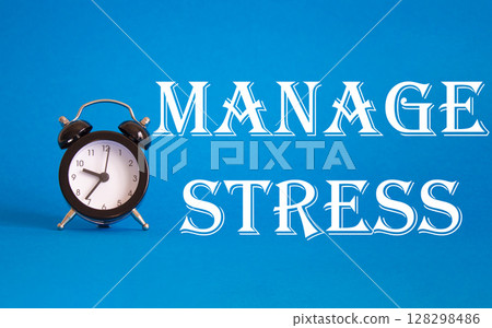 Manage stress symbol. Concept word Manage stress on Beautiful blue background with alarm clock. Medicine and Manage stress concept. Copy space 128298486