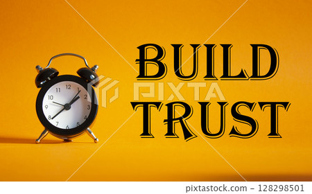 Build trust symbol. Beautiful orange background with alarm clock. Business and Build trust concept. Copy space. 128298501