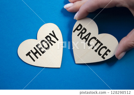 Theory or Practice symbol. Concept word Theory or Practice on wooden hearts. Businessman hand. Beautiful blue background. Business and Theory or Practice concept. Copy space Theory or Practice symbol. Concept word Theory or Practice on wooden hearts. Businessman hand. Beautiful blue background. Business and Theory or Practice concept. Copy space 128298512