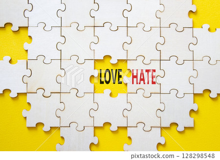 Love vs Hate symbol. Concept word Love vs Hate on wooden puzzle. Beautiful yellow background. Business and Love vs Hate concept. Copy space Love vs Hate symbol. Concept word Love vs Hate on wooden puzzle. Beautiful yellow background. Business and Love vs Hate concept. Copy space 128298548
