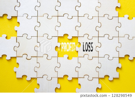 Profit or Loss symbol. Concept word Profit or Loss on wooden puzzle. Beautiful yellow background. Business and Profit or Loss concept. Copy space Profit or Loss symbol. Concept word Profit or Loss on wooden puzzle. Beautiful yellow background. Business and Profit or Loss concept. Copy space 128298549