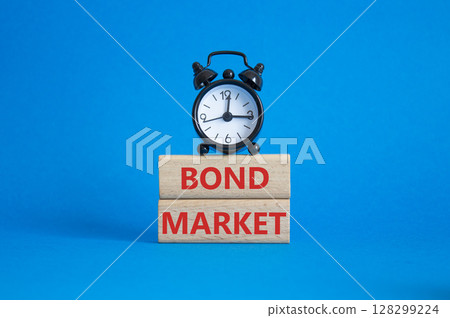 Bond Market symbol. Concept words Bond Market on wooden blocks. Beautiful blue background with alarm clock. Business and Bond Market concept. Copy space. 128299224