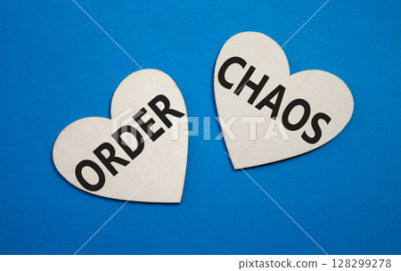 Chaos or Order symbol. Concept word Chaos or Order on wooden hearts. Beautiful blue background. Business and Chaos or Order concept. Copy space 128299278