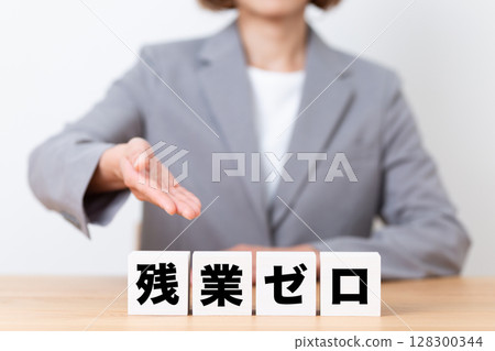 A middle-aged female business woman wearing a suit and a block of zero overtime 128300344