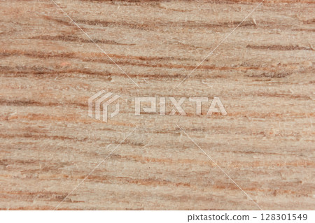 Close-up of a brown wood texture with visible grain patterns. 128301549