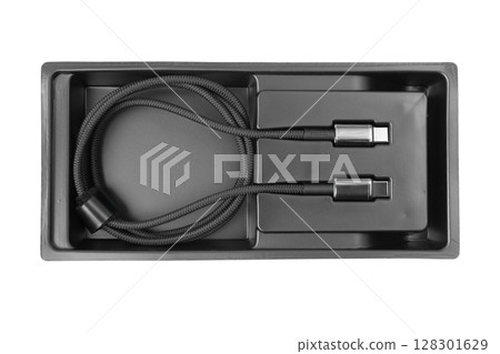 Black USB-C cable in a tray, coiled neatly in packaging. 128301629