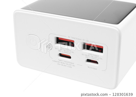 White charger with multiple USB ports for device charging. White charger with multiple USB ports for device charging. 128301639