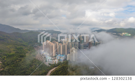March 2 2025 High-Rise Cityscape with Rolling Hills and Foggy Clouds 128302138