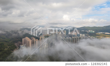 March 2 2025 High-Rise Buildings Amid Mist Over Lush Green Hills 128302141