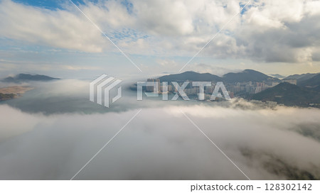 March 2 2025 Cityscape Surrounded by Misty Mountains, Hong Kong 128302142