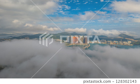 March 2 2025 Skyscrapers Emerging Through Mist in a Mountainous 128302143