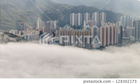 March 2 2025 City Skyline With Misty Clouds and Mountain Background 128302173