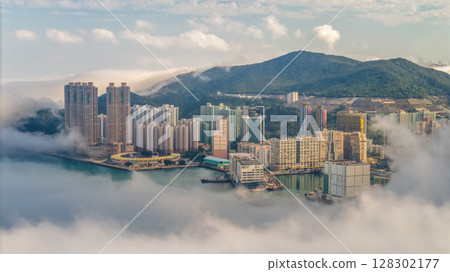 March 2 2025 Cityscape Surrounded by Misty Mountains, Hong Kong 128302177