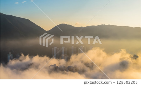 March 2 2025 View of a City With Foggy Mountains and Waterfront Scenery March 2 2025 View of a City With Foggy Mountains and Waterfront Scenery 128302203