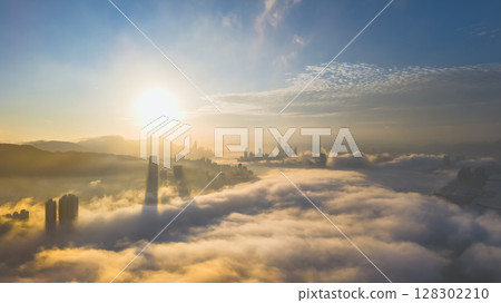 March 2 2025 Captivating Urban Skyline Shrouded in Morning Mist During Sunset 128302210