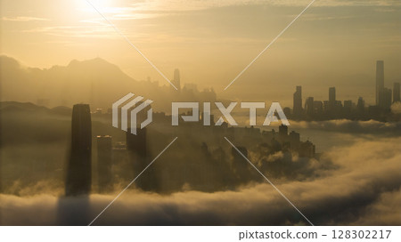 March 2 2025 Captivating Urban Skyline Shrouded in Morning Mist During Sunset 128302217