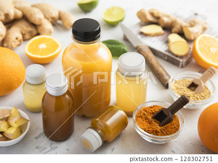 Various bottles of immune boost shot drink with ginger and orange and turmeric. 128302751