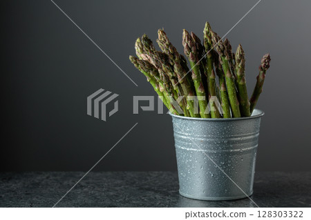 Fresh asparagus on a black stone table. Fresh asparagus on a black stone table. 128303322
