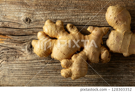 Ginger on a old wooden board. Ginger on a old wooden board. 128303352