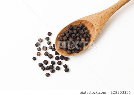 Black pepper on a white background 128303395