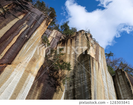 The rock face and blue sky of the Uriwari Rock Garden: A geometrical landscape created by the vertically carved stone surface 128303841